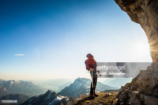 alone climber lokking at mountain - mountain climber stock pictures, royalty-free photos & images