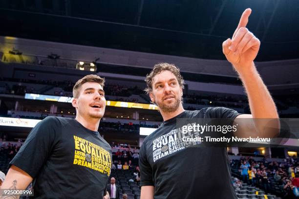 Juan Hernangomez of the Denver Nuggets, left, speaks with Pau Gasol of the San Antonio Spurs at Pepsi Center on February 23, 2018 in Denver,...