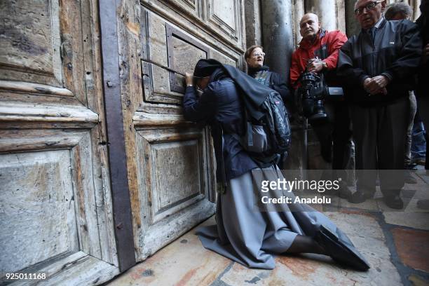 Christian pilgrims pray outside the closed Church of the Holy Sepulcher, in the Old City of Jerusalem on February 27, 2018. Heads of the Christian...