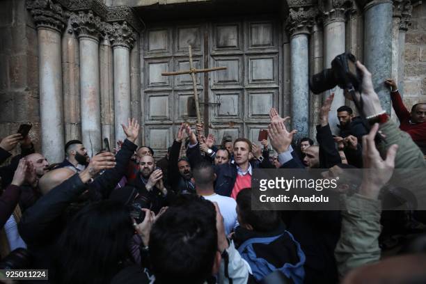 People gather outside the closed Church of the Holy Sepulcher, in the Old City of Jerusalem on February 27, 2018. Heads of the Christian Churches in...