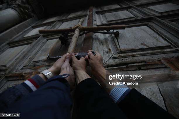 People gather outside the closed Church of the Holy Sepulcher, in the Old City of Jerusalem on February 27, 2018. Heads of the Christian Churches in...