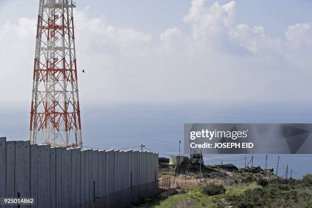 Picture taken on February 24, 2018 from Lebanon's southern border town of Naqura on the border with Israel, south of Beirut, shows the concrete wall...