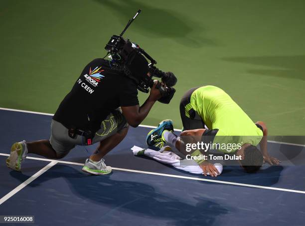 Malek Jaziri of Tunisia kisses the court after his win against Grigor Dimitrov of Bulgaria on day two of the ATP Dubai Duty Free Tennis Championships...