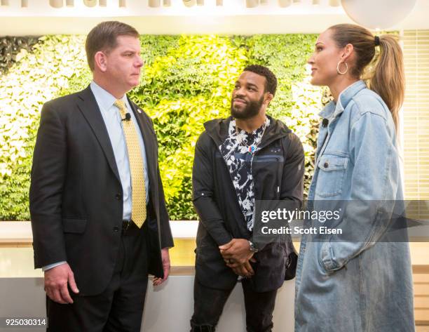 Boston Mayor Martin J. Walsh, left, talks with ASICS Elite Athletes Jordan Burroughs, center, and Lolo Jones at the grand opening of the ASICS...