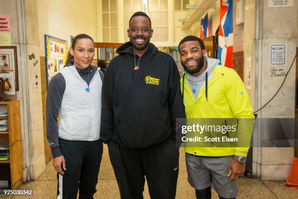 Elite Athletes Lolo Jones, left, and Jordan Burroughs, right, with Michael J. Perkins Elementary School Principal Craig Martin on February 27, 2018...