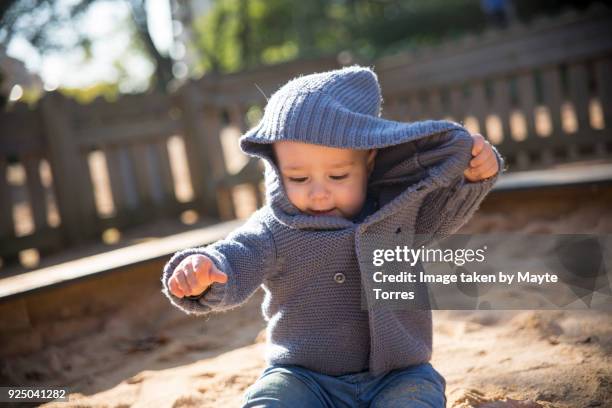 baby boy messing with his hood - sandy messing stock pictures, royalty-free photos & images