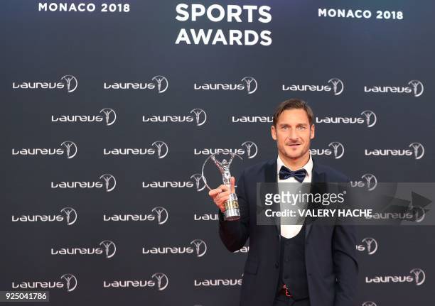 Former Italian football player and AS Roma forward Francesco Totti poses with his Laureus academy exceptional achievement award during the 2018...