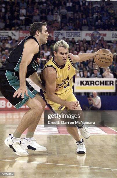 Shane Heal for the Sydney Kings, drives past Jason Smith for the Titans, during the game between the Sydney Kings and the Victoria Titans, which was...