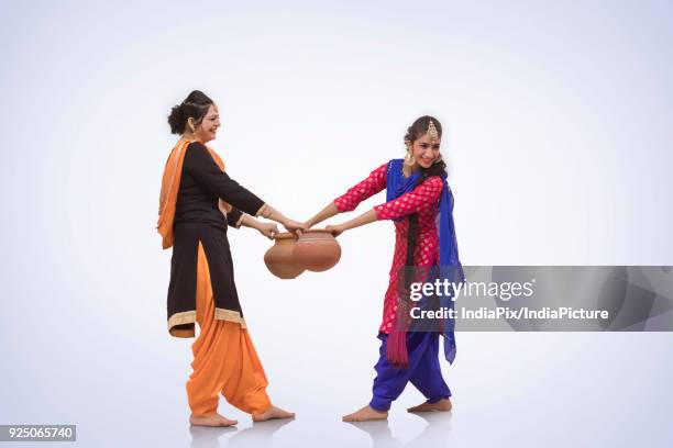 two women dancing with earthen pot - north indian food stock pictures, royalty-free photos & images