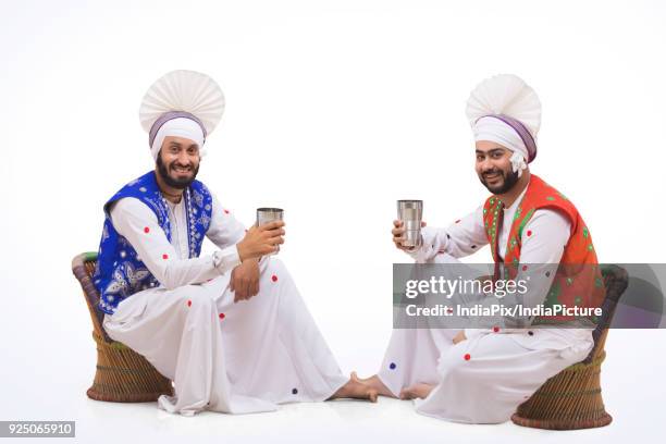 sikh people drinking lassi during baisakhi celebrations - north indian food stock pictures, royalty-free photos & images