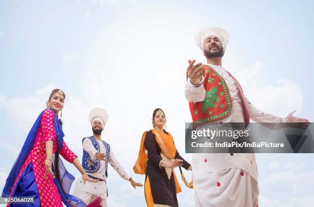 sikh people dancing - people celebrate lohri festival stock-fotos und bilder