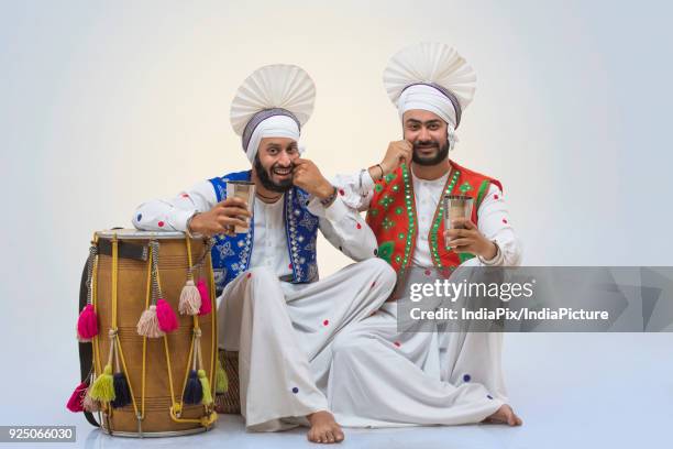 sikh people drinking lassi during baisakhi celebrations - north indian food stock pictures, royalty-free photos & images