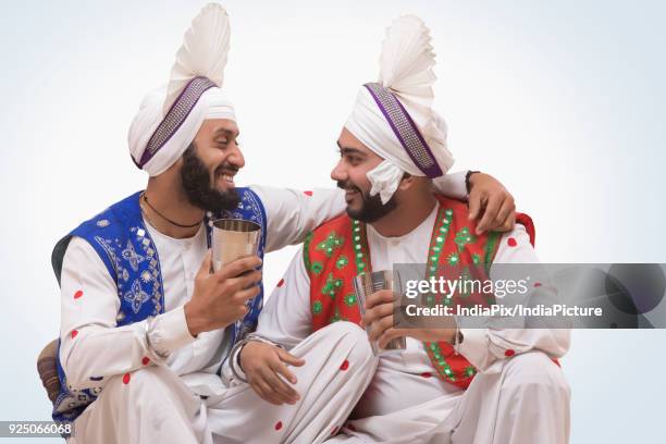 sikh people drinking lassi during baisakhi celebrations - lohri festival stock-fotos und bilder