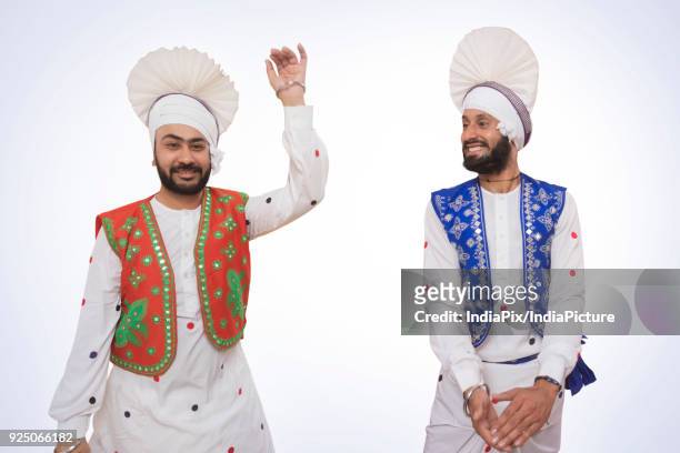 sikh men dancing - people celebrate lohri festival stock-fotos und bilder