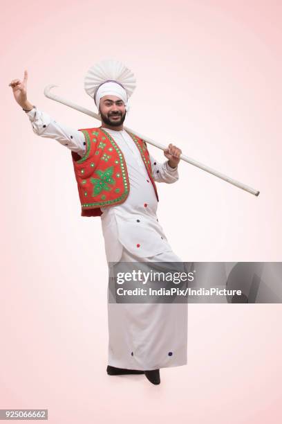 standing of sikh man with stick - people celebrate lohri festival bildbanksfoton och bilder