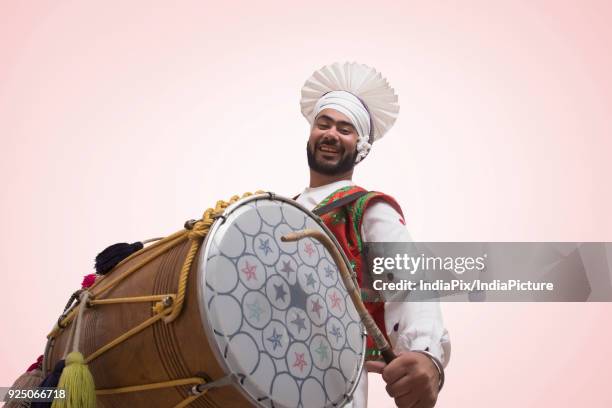 sikh man playing on a dhol - baisakhi stock pictures, royalty-free photos & images