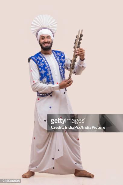 portrait of sikh man holding a chimta - people celebrate lohri festival bildbanksfoton och bilder
