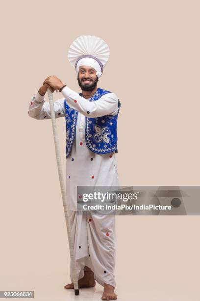 standing of sikh man with stick - people celebrate lohri festival bildbanksfoton och bilder