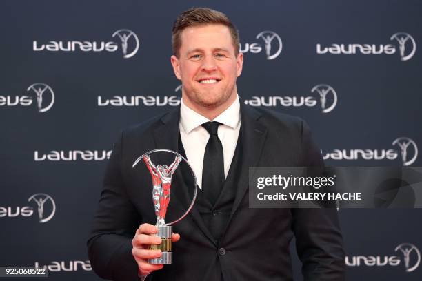 Texas Houston's defensive end Justin James Watt poses with his Laureus inspiration award trophy during the 2018 Laureus World Sports Awards ceremony...