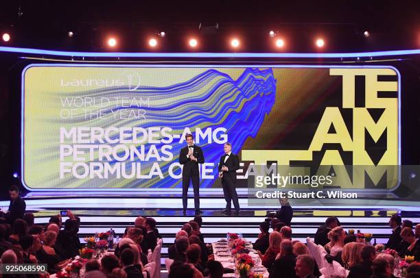 Laureus Academy member Mick Doohan looks on as the winner of the award for Laureus World Team of the Year ,Toto Wolff of Mercedes Benz/Patronas F1...