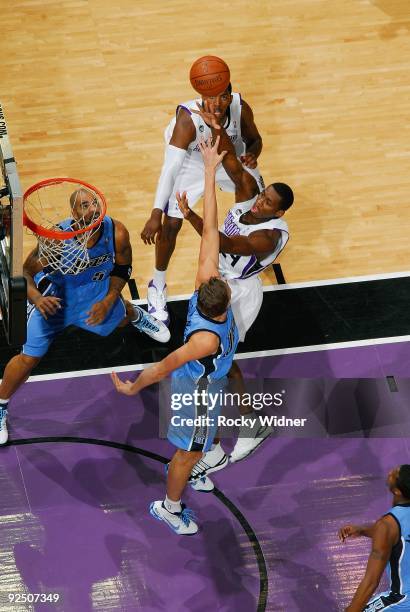 Desmond Mason of the Sacramento Kings hooks a shot over Mehmet Okur of the Utah Jazz during the preseason game on October 23, 2009 at Arco Arena in...