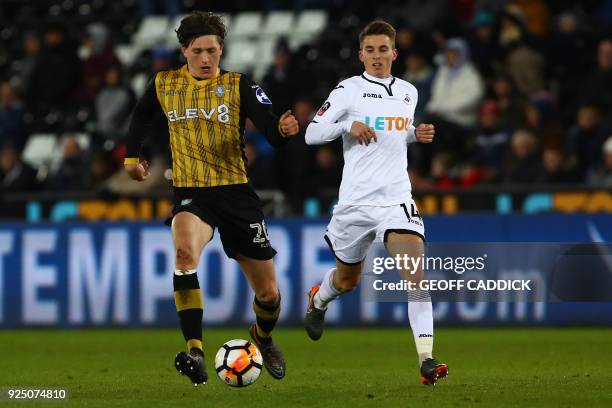 Sheffield Wednesday's English striker Adam Reach vies with Swansea City's English midfielder Tom Carroll during the English FA Cup 5th round replay...