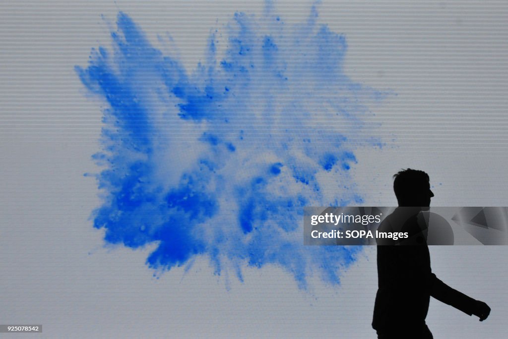 A visitor seen walking past a Samsung display screen at the...