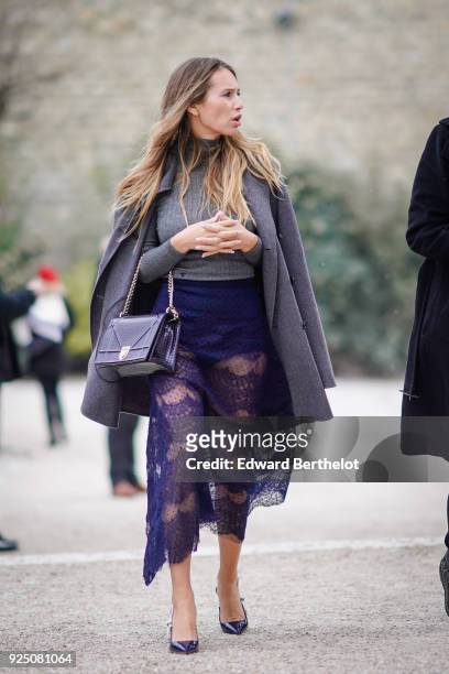 Dylan Penn wears a gray coat, a purple mesh lace dress, a Dior bag, outside Dior, during Paris Fashion Week Womenswear Fall/Winter 2018/2019, on...