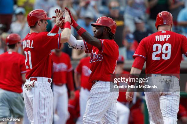 Cesar Hernandez of the Philadelphia Phillies celebrates with Collin Cowgill after hitting a three run homer during the third inning of the Spring...
