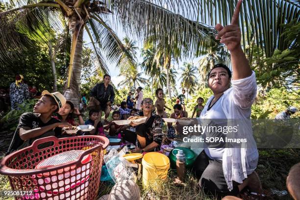 Bajau woman serves food during a water festival held annually by the inhabitants of kalapuan Island. The festival is a purification ritual aimed at...