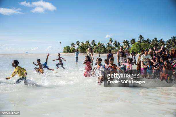 Children run during a water festival held annually by the inhabitants of kalapuan Island. The festival is a purification ritual aimed at absolving...