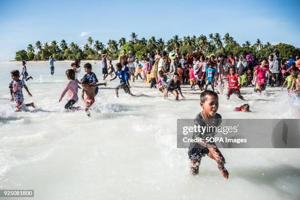 Children run during a water festival held annually by the inhabitants of kalapuan Island. The festival is a purification ritual aimed at absolving...