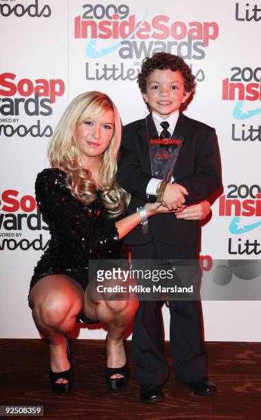 Actor Alex Bain poses with Brooke Kinsella as he holds the Best Young Actor Award at Inside Soap Awards held at Sketch on September 28, 2009 in...
