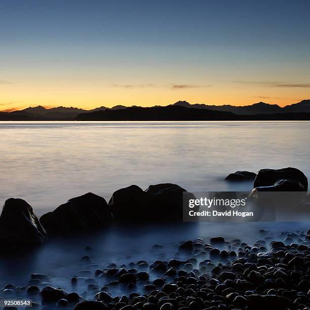 olympic mountains over puget sound - alki point stock pictures, royalty-free photos & images