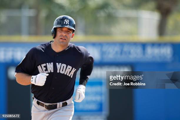 Danny Espinosa of the New York Yankees rounds the bases after hitting a solo home run in the fourth inning of a Grapefruit League spring training...