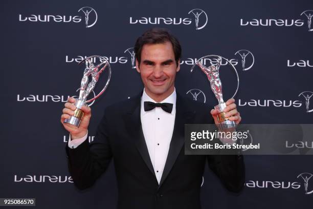 Tennis player Roger Federer holds his awards for Laureus World Comeback of the Year 2018 and Laureus World Sportsman of the Year 2018 during the...