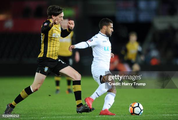 Wayne Routledge of Swansea breaks away from Adam Reach of Sheffield Wednesday during the Emirates FA Cup Fifth Round Replay match between Swansea...