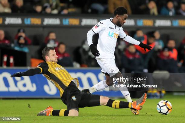 Nathan Dyer of Swansea City is tackled by Daniel Pudil of Sheffield Wednesday during The Emirates FA Cup Fifth Round Replay match between Swansea...