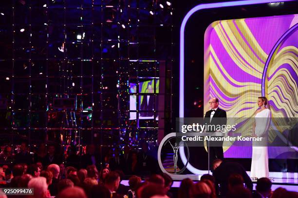 Prince Albert II of Monaco speaks on stage with his wife Charlene,Princess of Monaco during the 2018 Laureus World Sports Awards show at Salle des...