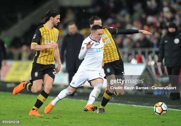 Swansea City's Connor Roberts vies for possession with Sheffield Wednesday's David Jones as George Boyd watches on during the The Emirates FA Cup...