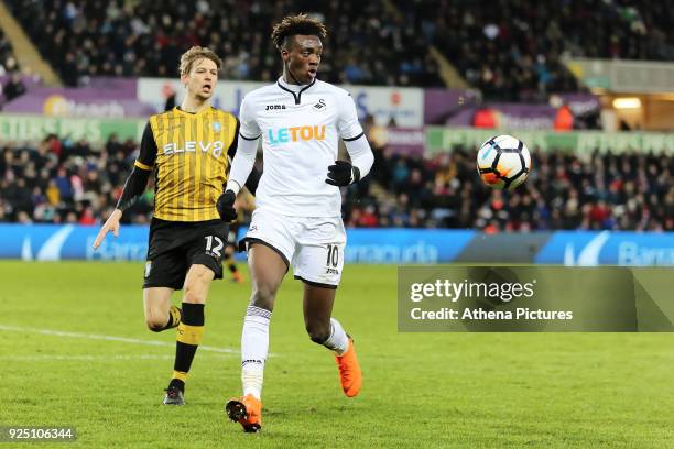 Tammy Abraham of Swansea City closely followed by Glenn Loovens of Sheffield Wednesday during The Emirates FA Cup Fifth Round Replay match between...
