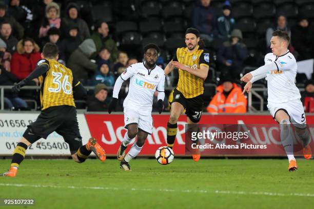 Connor Roberts of Swansea City shows team Nathan Dyer l where to pass the ball as he gets past Daniel Pudil and George Boyd of Sheffield Wednesday...