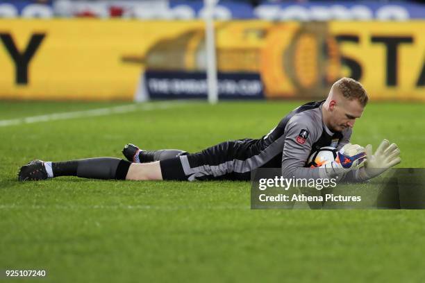 Cameron Dawson of Sheffield Wednesday grabs the ball on the ground during The Emirates FA Cup Fifth Round Replay match between Swansea City and...