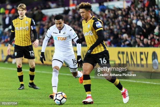 Martin Olsson of Swansea City closely follows Liam Palmer of Sheffield Wednesday during The Emirates FA Cup Fifth Round Replay match between Swansea...