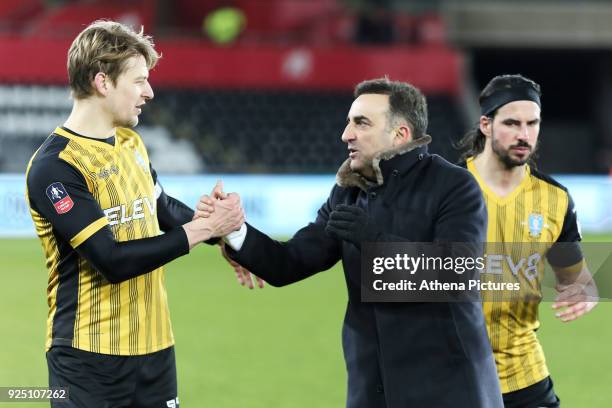 Swansea manager Carlos Carvalhal greets Glenn Loovens of Sheffield Wednesday during The Emirates FA Cup Fifth Round Replay match between Swansea City...