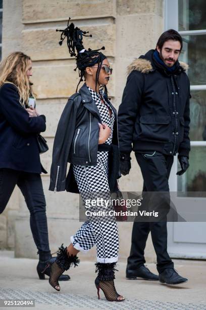Selah Marley wearing plaid overall, leather jacket is seen outside Dior on February 27, 2018 in Paris, France.