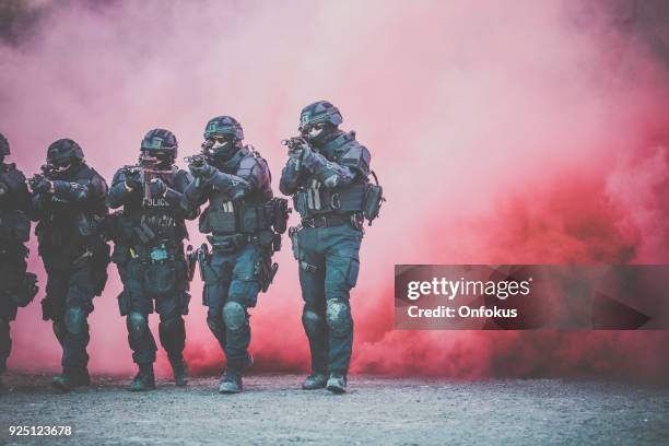 swat police officers shooting with firearm - terrorist attack stock pictures, royalty-free photos & images