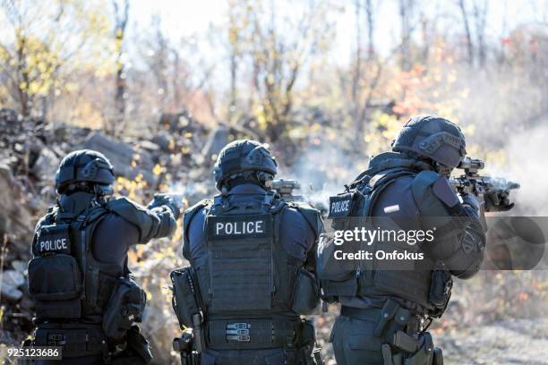 swat police officers shooting with firearm - task force stock pictures, royalty-free photos & images