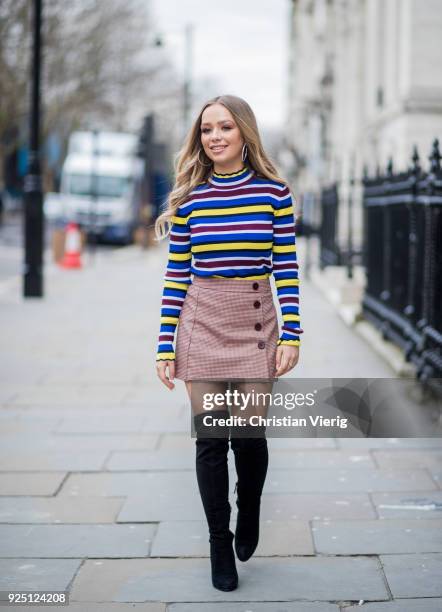 British singer Connie Talbot wearing striped top, skirt, black overknees boots seen during London Fashion Week February 2018 on February 18, 2018 in...