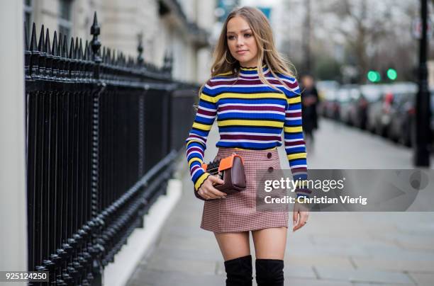 British singer Connie Talbot wearing striped top, skirt, black overknees boots, Aigner bag seen during London Fashion Week February 2018 on February...